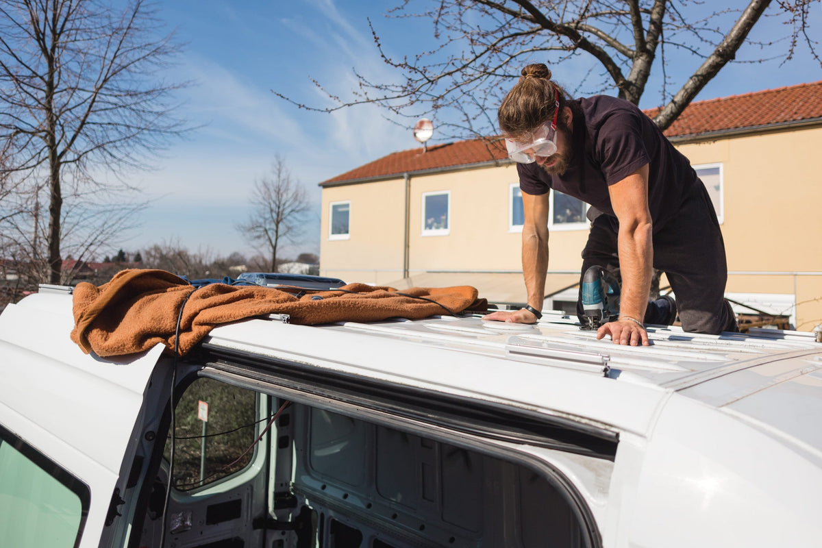 Man working on the roof of a van
