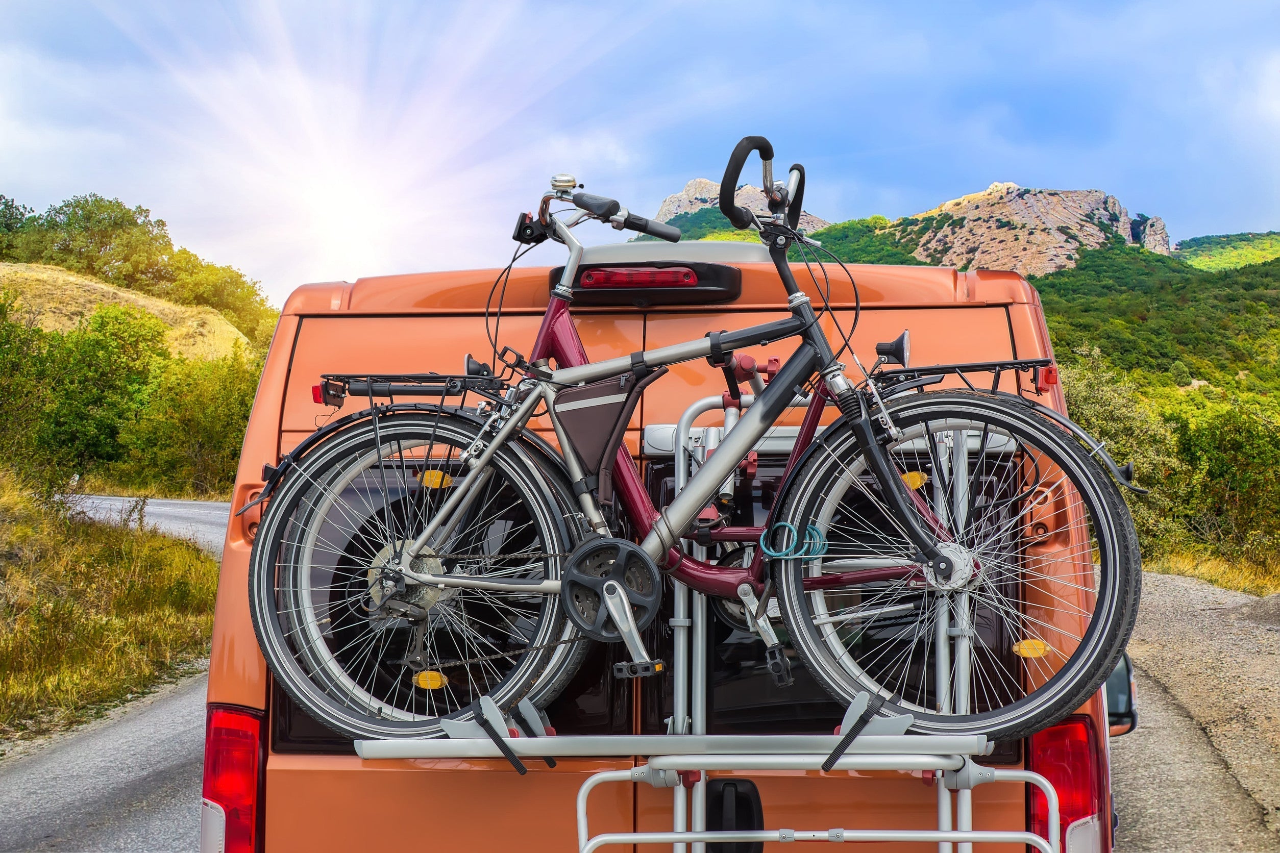 Bicycles on a bike rack on the back of a van