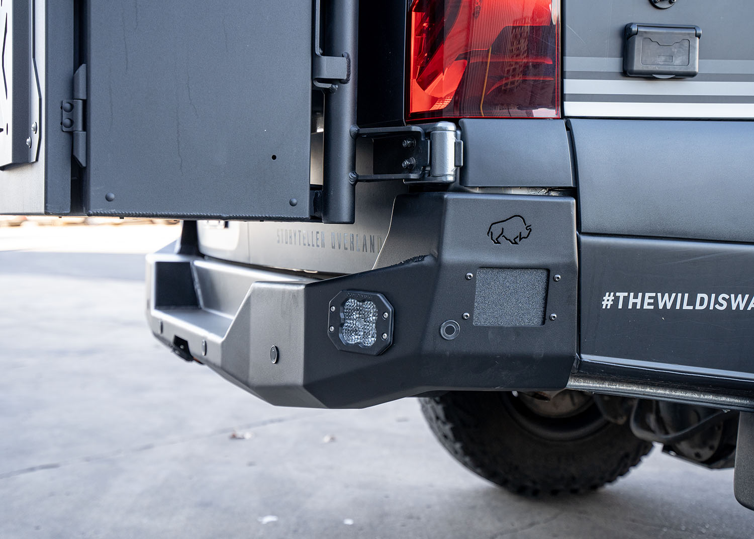 Side view of the ROAMBUILT Rear Bumper on a Mercedes Sprinter van, focusing on the integrated lane change assist sensor and flush-mounted light, showcasing the bumper’s compatibility with safety systems and its rugged, functional design.
