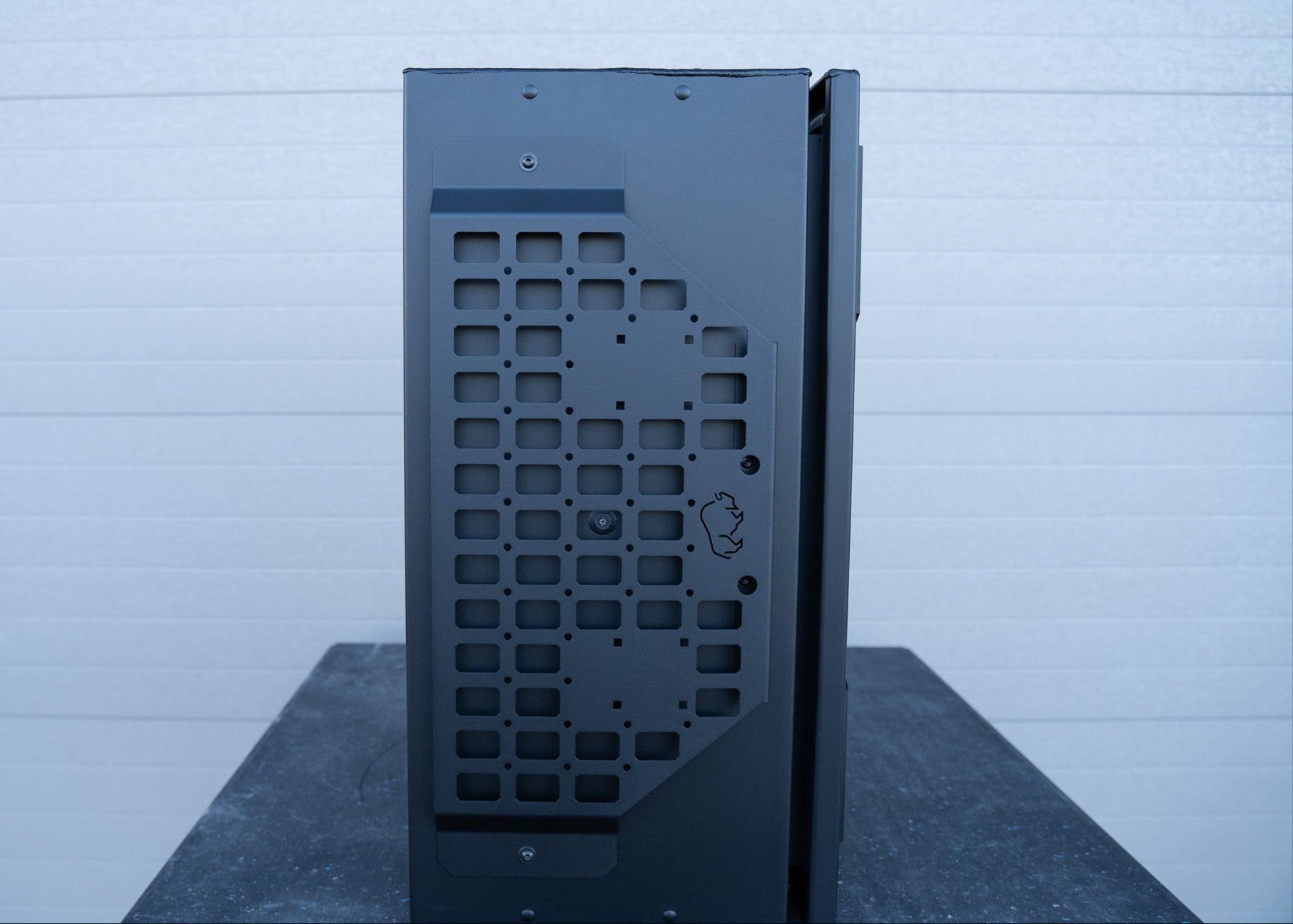 Side profile view of the ROAMBUILT Universal Aluminum Storage Box, showcasing the sleek black semi-textured powder coat finish and durable aluminum construction.