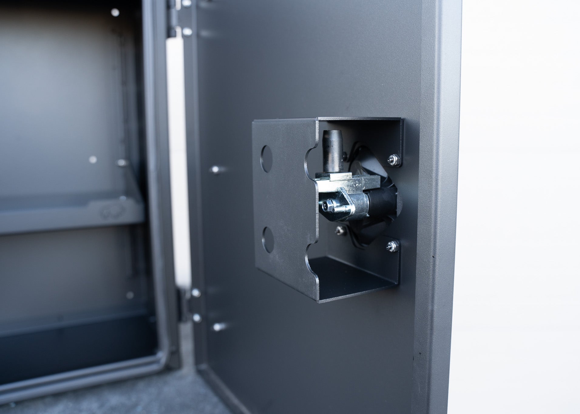 Detailed close-up of the inside mechanism of the lockable compression latch on the ROAMBUILT Universal Aluminum Storage Box, highlighting the latch components and secure fit.