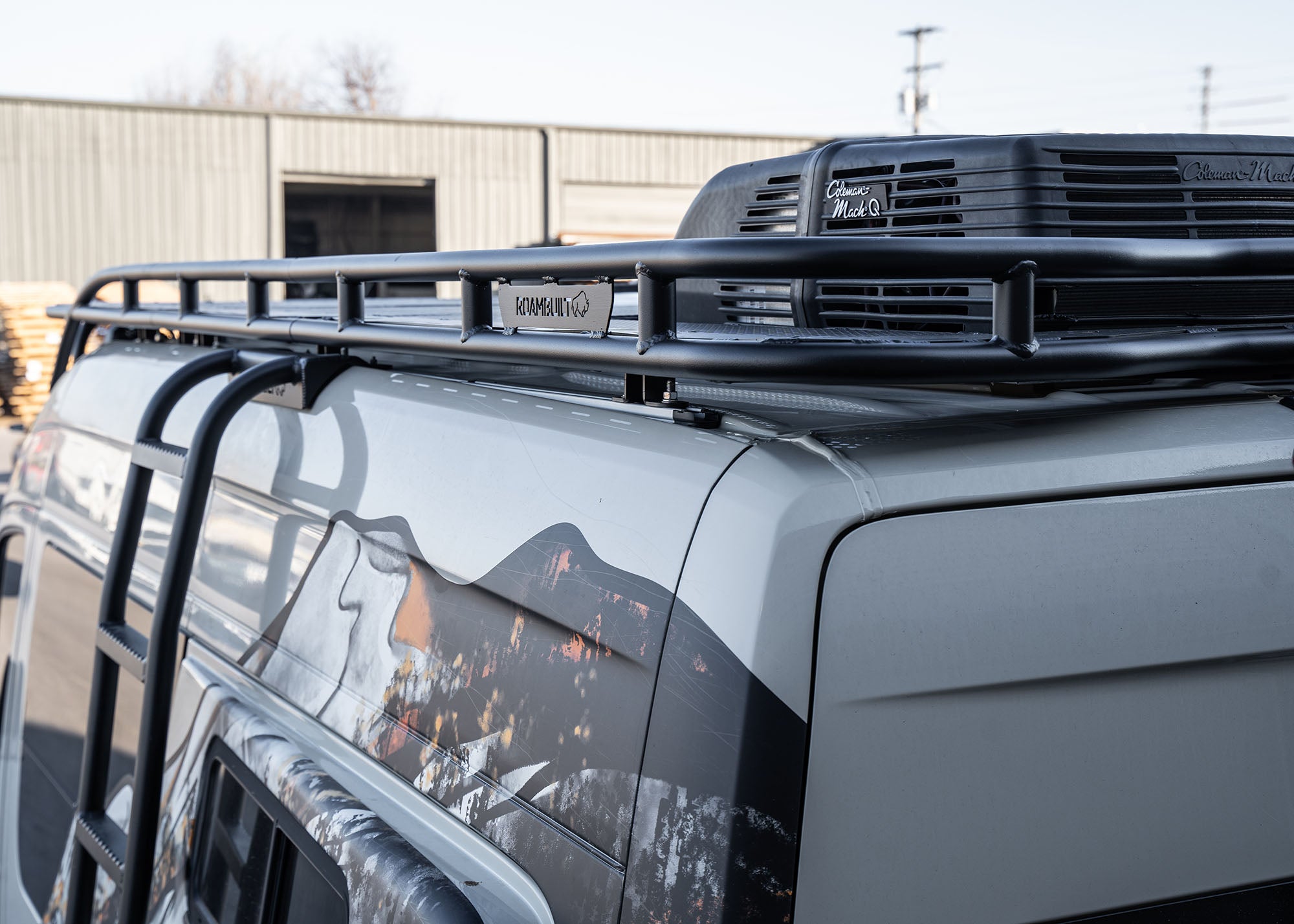 Driver-side view from the rear looking forward, showing the Safari 2.0 roof rack’s logo, rear mounting point, and seamless integration with factory roof rails.
