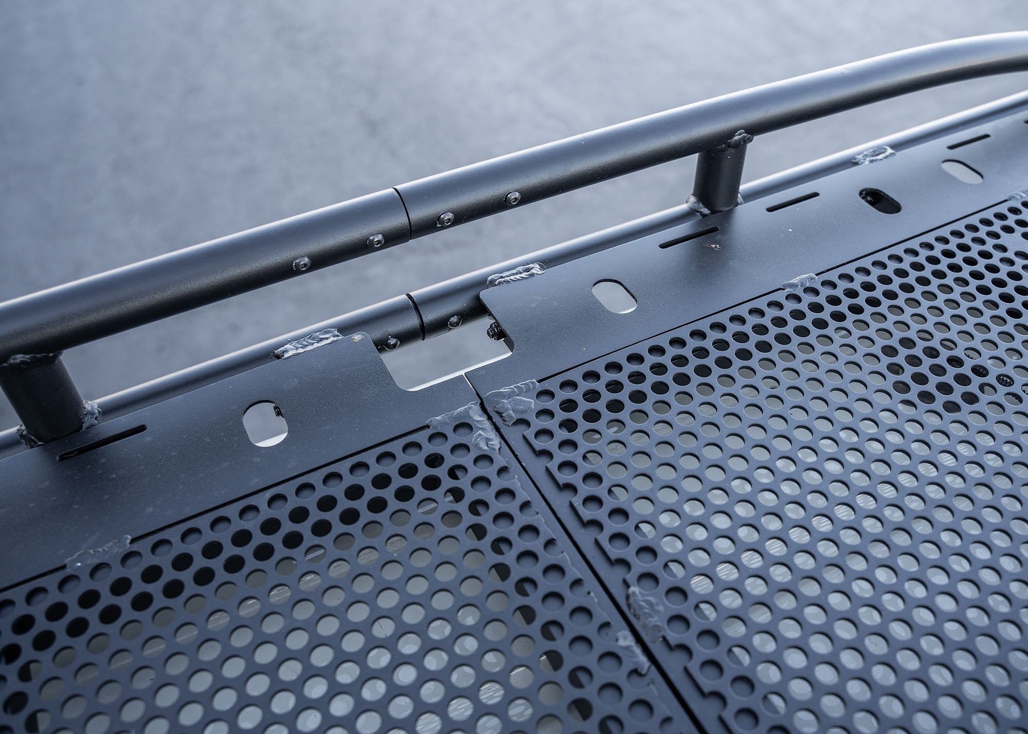 Close-up view of the Safari 2.0 roof rack connection point, highlighting the secure, modular joint between rack sections and durable black hardware.