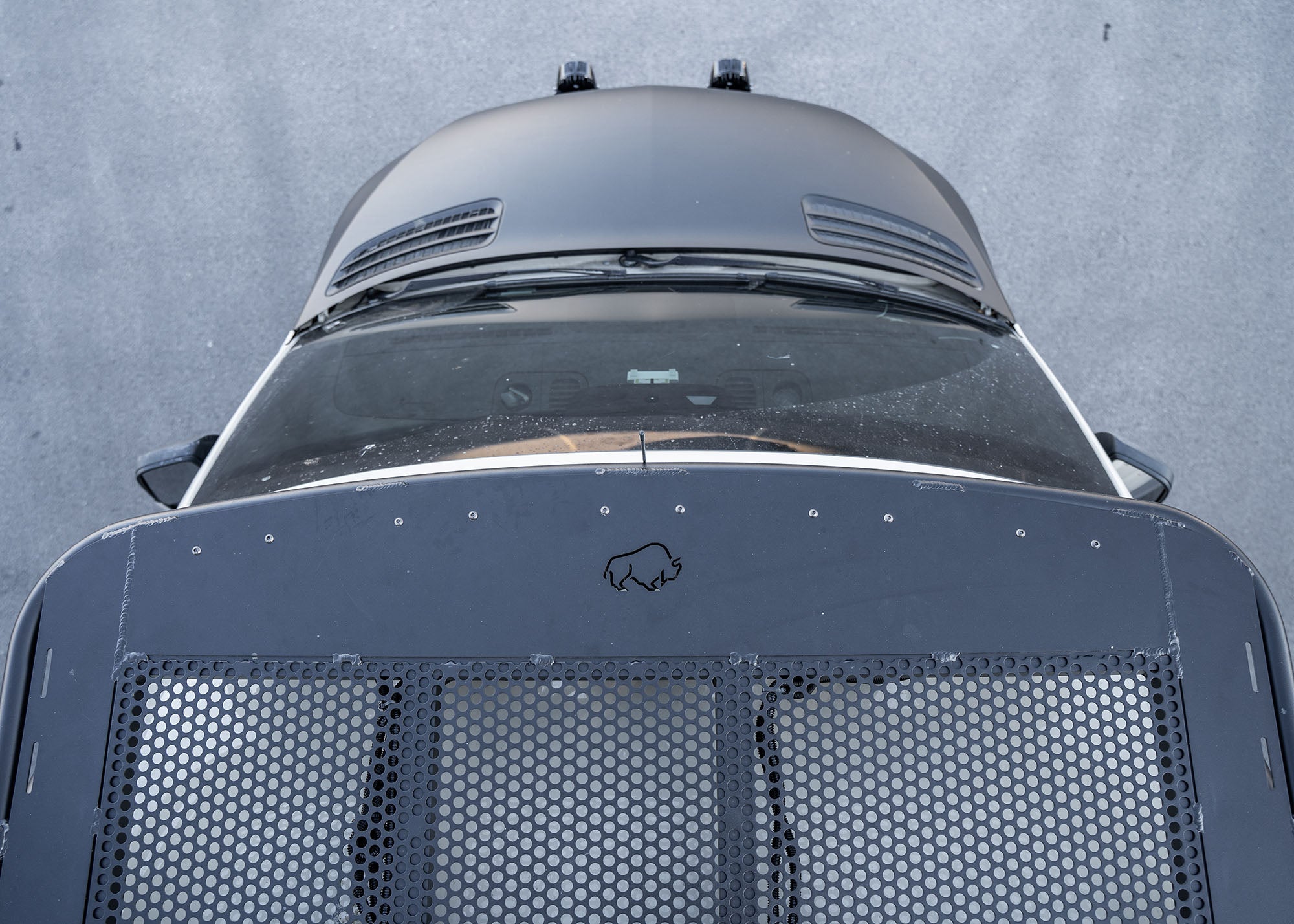 Top-down view of the front section of the Safari 2.0 roof rack showing the ROAMBUILT logo and curved front profile.