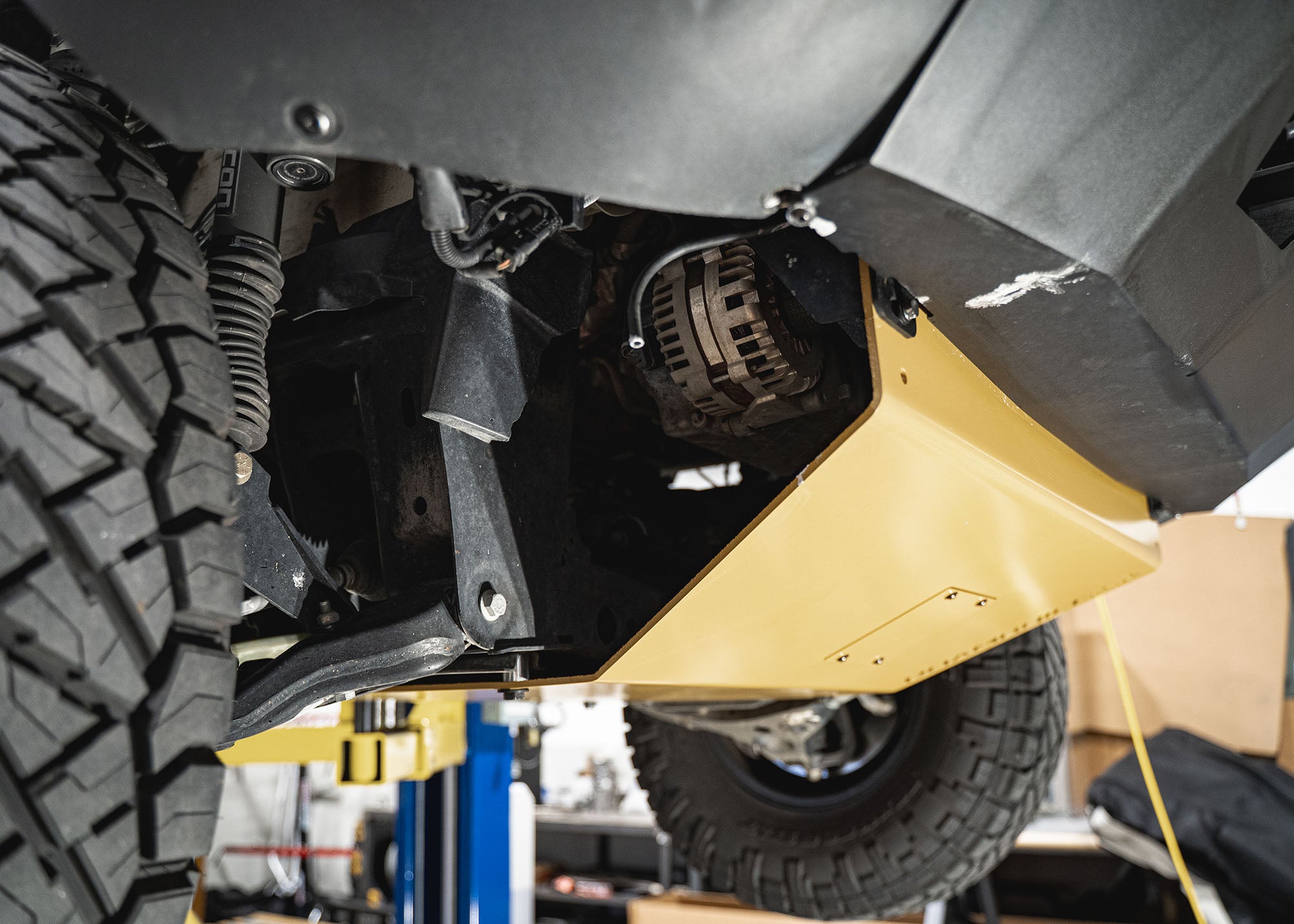 Underside view of the Mercedes Sprinter skid plate showing the removable oil change access panel and full coverage of the skid plate protecting the underbody.