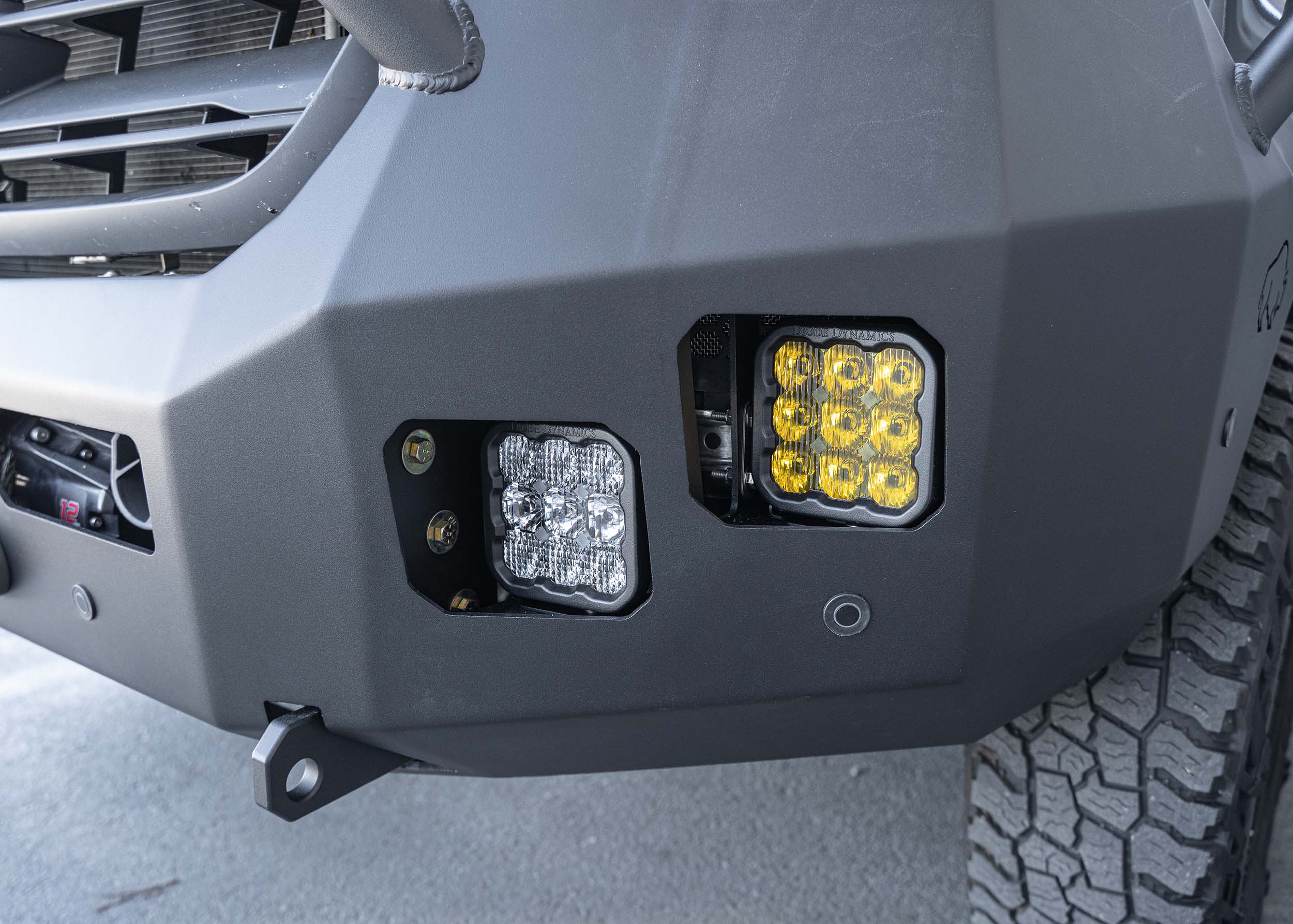 Close-up view of the Full Guard Front Bumper's light pockets on a Mercedes Sprinter van, showcasing the precision-cut square openings designed to fit most LED lights, with a rugged, powder-coated aluminum finish for durability and style