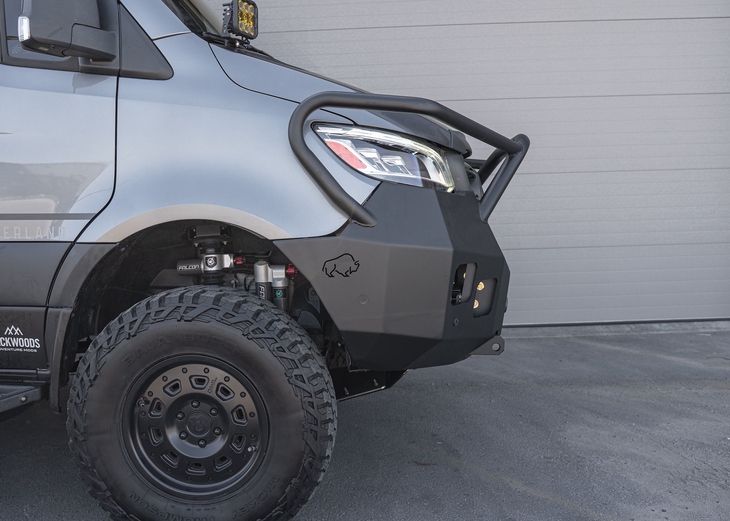 Side profile view of a Mercedes Sprinter van featuring the Full Guard Front Bumper, highlighting its sleek, lightweight hybrid steel and aluminum construction, seamlessly integrated for enhanced front-end protection and off-road capability.