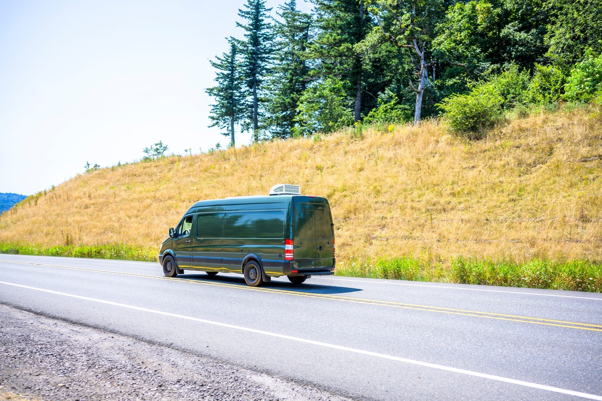 Sprinter van driving down the road
