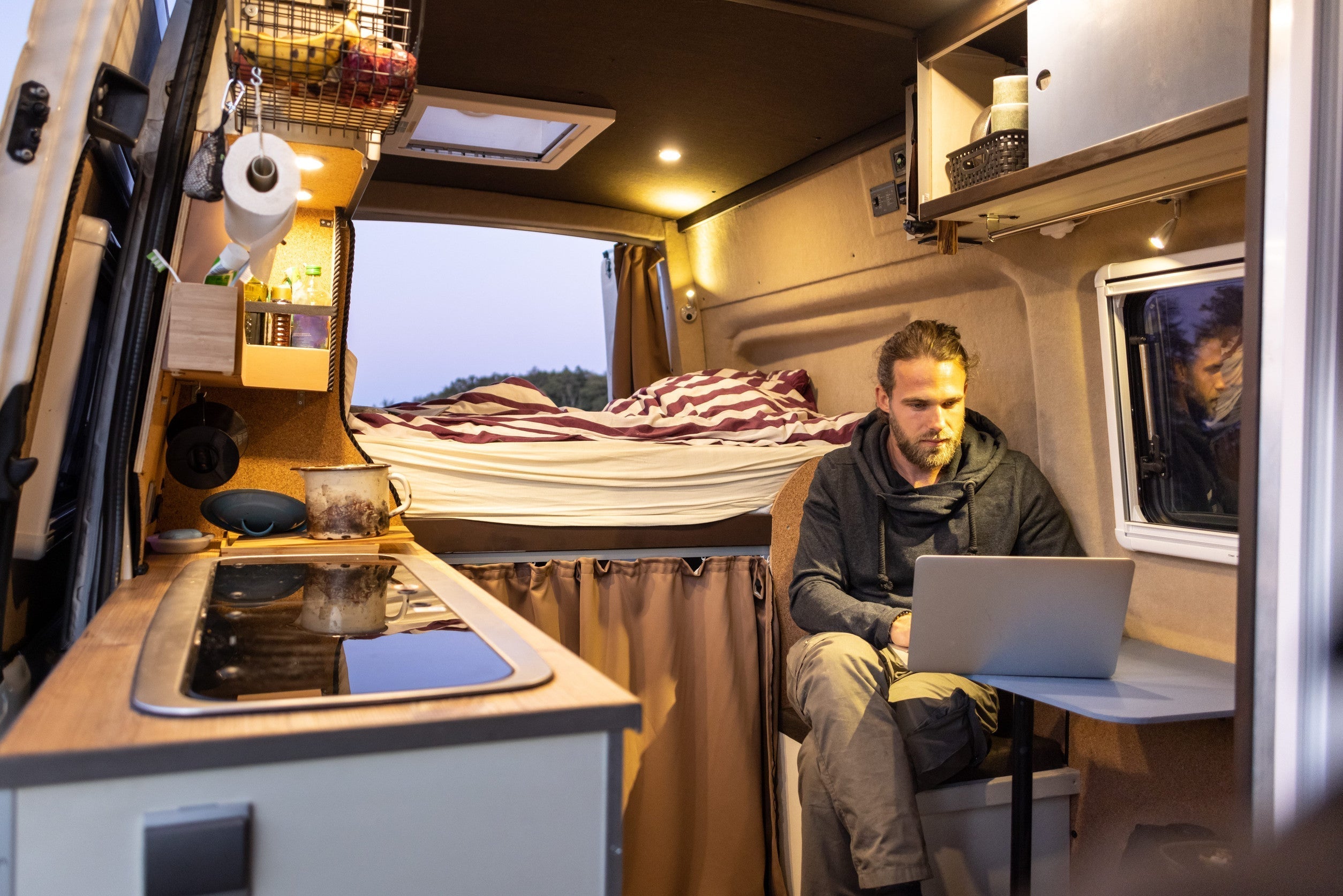 Man inside of his van that is converted to a living space